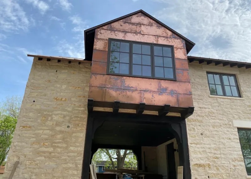 Copper metal panel facade on a stone building for Roof Repair in White Oak